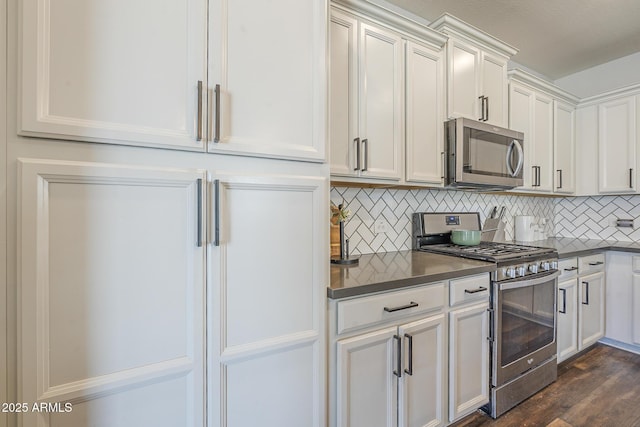 9752 E Torino Ave, Mesa, AZ 85212 - kitchen featuring stainless steel appliances, dark countertops, backsplash, white cabinetry, and dark wood-type flooring