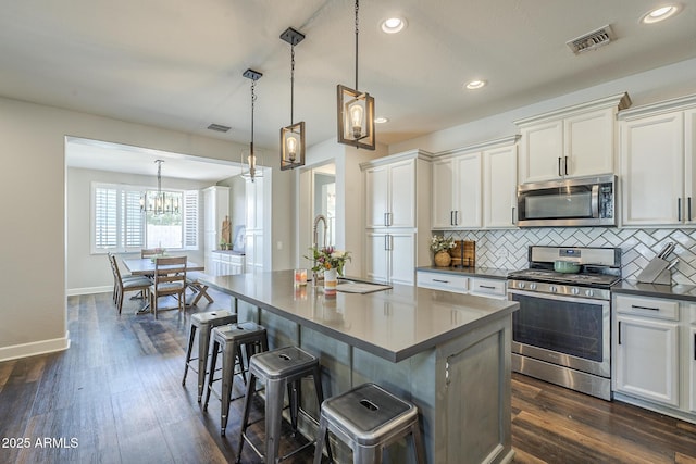 9752 E Torino Ave, Mesa, AZ 85212 - kitchen featuring appliances with stainless steel finishes, white cabinets, decorative backsplash, and recessed lighting