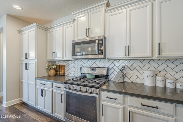 9752 E Torino Ave, Mesa, AZ 85212 - kitchen with appliances with stainless steel finishes, dark countertops, tasteful backsplash, dark wood finished floors, and recessed lighting