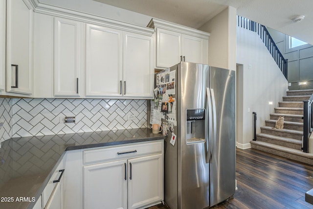 9752 E Torino Ave, Mesa, AZ 85212 - kitchen with stainless steel refrigerator with ice dispenser, dark countertops, decorative backsplash, white cabinets, and dark wood-type flooring
