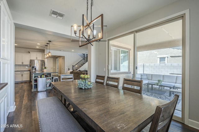 9752 E Torino Ave, Mesa, AZ 85212 - dining room featuring dark wood-style flooring, a chandelier, recessed lighting, and stairway