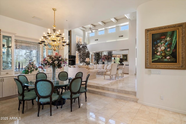 7728 E Mary Sharon Dr, Scottsdale, AZ 85266 - dining area with a chandelier, a towering ceiling, baseboards, and radiator heating unit