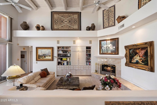 7728 E Mary Sharon Dr, Scottsdale, AZ 85266 - living area featuring ceiling fan, a high ceiling, a premium fireplace, and beamed ceiling