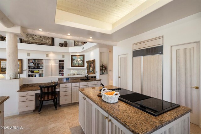 7728 E Mary Sharon Dr, Scottsdale, AZ 85266 - kitchen featuring a tray ceiling, black electric stovetop, paneled built in refrigerator, recessed lighting, and a center island