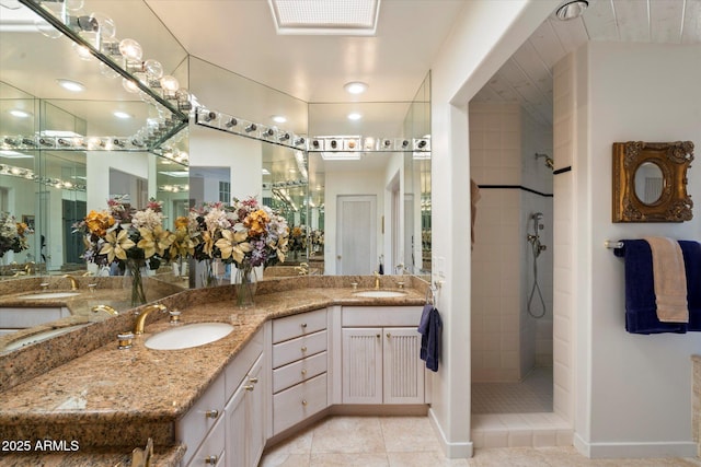 7728 E Mary Sharon Dr, Scottsdale, AZ 85266 - full bath featuring tile patterned flooring, double vanity, tiled shower, and baseboards