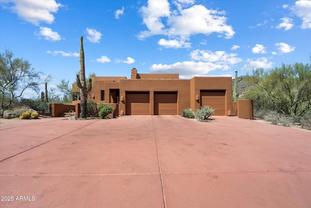 7728 E Mary Sharon Dr, Scottsdale, AZ 85266 - adobe home featuring stucco siding, driveway, and an attached garage