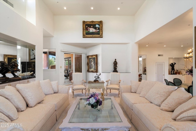 7728 E Mary Sharon Dr, Scottsdale, AZ 85266 - living area featuring a towering ceiling, a chandelier, and recessed lighting