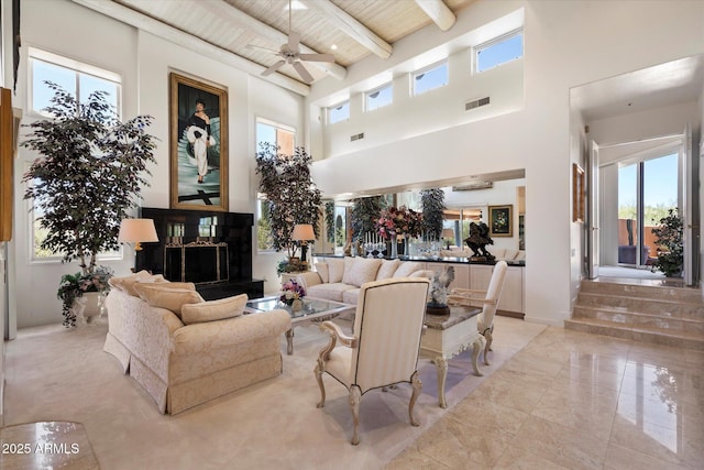7728 E Mary Sharon Dr, Scottsdale, AZ 85266 - living area with a high ceiling, ceiling fan, wood ceiling with exposed beams, and light marble finish flooring