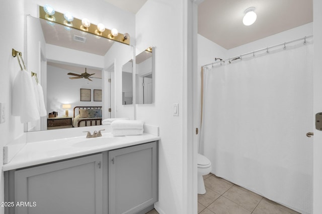 ensuite bathroom featuring vanity, a ceiling fan, ensuite bathroom, tile patterned floors, and toilet