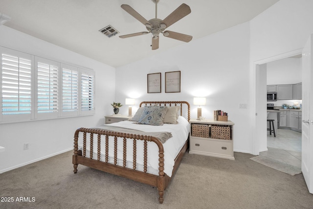 carpeted bedroom featuring lofted ceiling, baseboards, visible vents, and ceiling fan