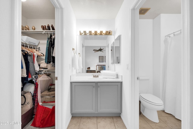 full bath featuring tile patterned floors, visible vents, toilet, ceiling fan, and vanity