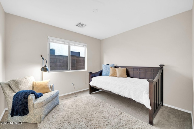 carpeted bedroom featuring baseboards and visible vents