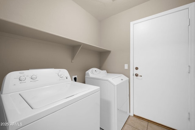 washroom with laundry area, light tile patterned floors, and independent washer and dryer