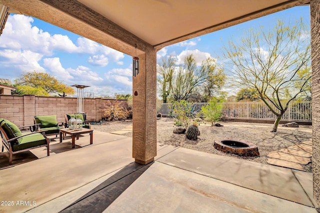 view of patio featuring a fire pit and a fenced backyard