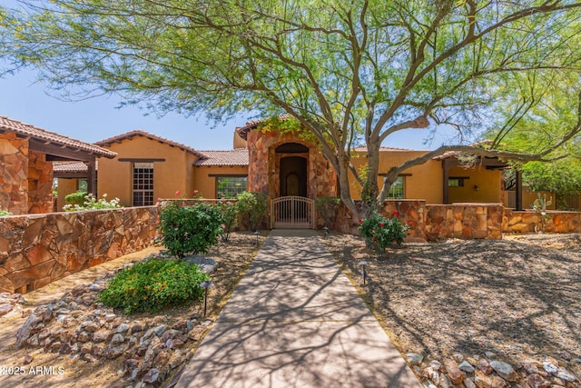 14619 E Desert Vista Trl, Scottsdale, AZ 85262 - view of front facade with a fenced front yard, a gate, a tiled roof, stone siding, and stucco siding