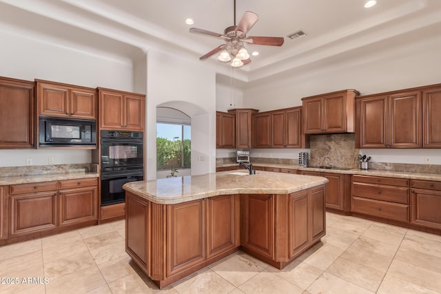 14619 E Desert Vista Trl, Scottsdale, AZ 85262 - kitchen featuring black appliances, a towering ceiling, ceiling fan, backsplash, and brown cabinets