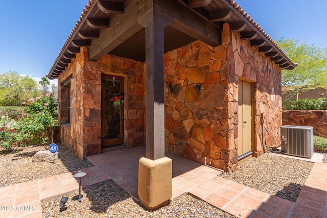 14619 E Desert Vista Trl, Scottsdale, AZ 85262 - doorway to property featuring stone siding, central AC, and a tiled roof