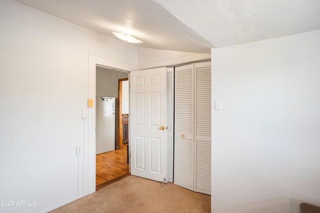 316 B St, Bisbee, AZ 85603 - unfurnished bedroom featuring light colored carpet, freestanding refrigerator, and a closet