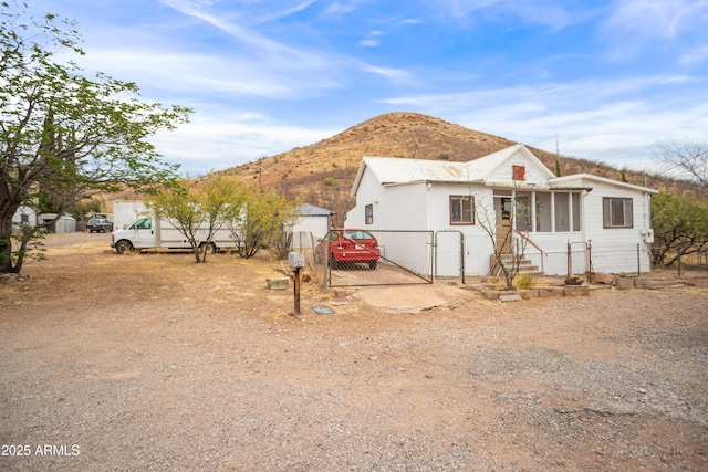 316 B St, Bisbee, AZ 85603 - view of front of house with a gate, a mountain view, and fence