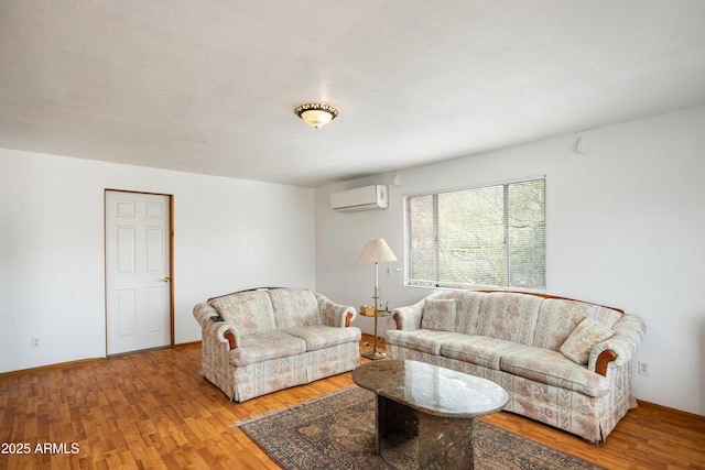 316 B St, Bisbee, AZ 85603 - living room featuring an AC wall unit, wood finished floors, and baseboards