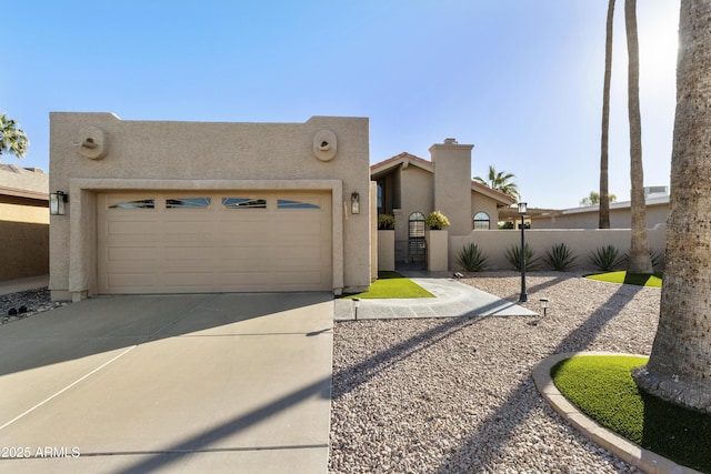 view of front facade featuring concrete driveway, an attached garage, fence, and stucco siding