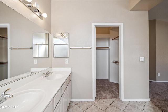 9422 W Monroe St, Peoria, AZ 85345 - bathroom featuring double vanity, a spacious closet, and tile patterned floors
