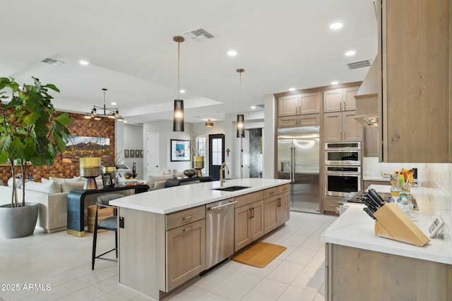 20797 W Rattler Rd, Buckeye, AZ 85396 - kitchen featuring appliances with stainless steel finishes, a sink, open floor plan, light stone counters, and light tile patterned flooring