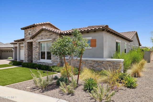 20797 W Rattler Rd, Buckeye, AZ 85396 - mediterranean / spanish home with stone siding, a tile roof, and an attached garage