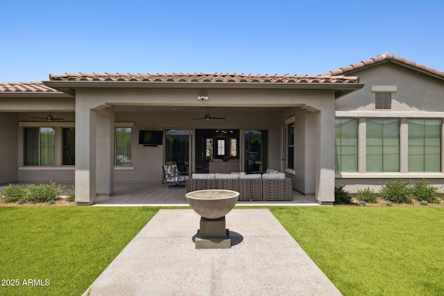 20797 W Rattler Rd, Buckeye, AZ 85396 - back of house featuring a ceiling fan, a patio, a lawn, and stucco siding