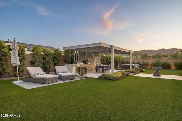 20797 W Rattler Rd, Buckeye, AZ 85396 - yard at dusk with area for grilling, a patio, and an outdoor living space