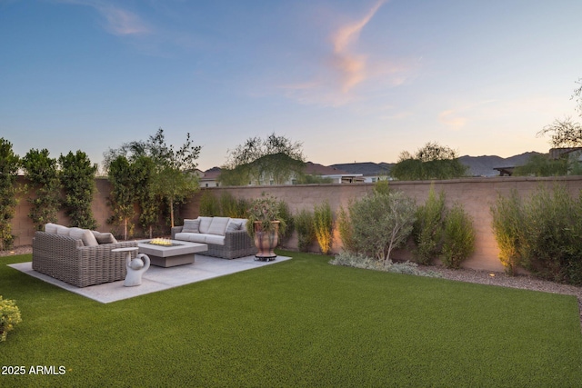 20797 W Rattler Rd, Buckeye, AZ 85396 - yard at dusk featuring an outdoor living space with a fire pit and a patio