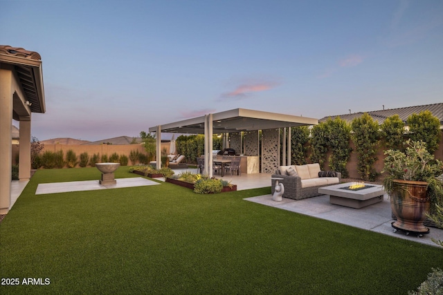 20797 W Rattler Rd, Buckeye, AZ 85396 - yard at dusk with an outdoor living space with a fire pit, a patio, and area for grilling