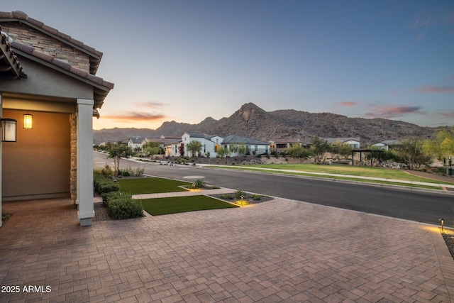 20797 W Rattler Rd, Buckeye, AZ 85396 - view of asphalt street featuring sidewalks, a mountain view, a residential view, and curbs