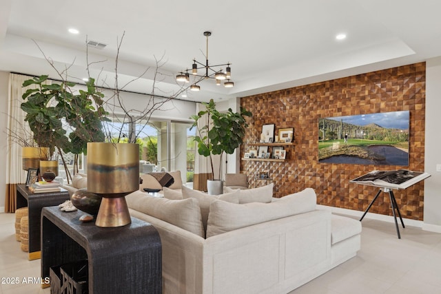 20797 W Rattler Rd, Buckeye, AZ 85396 - living area with an accent wall, recessed lighting, baseboards, and a chandelier