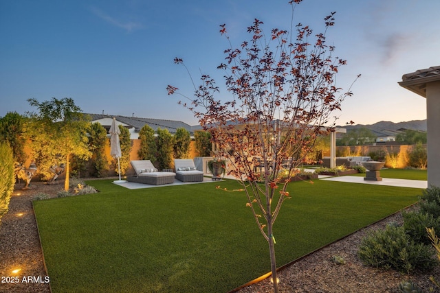 20797 W Rattler Rd, Buckeye, AZ 85396 - yard at dusk with a patio area
