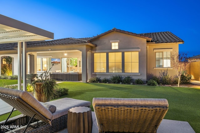 20797 W Rattler Rd, Buckeye, AZ 85396 - back of house with a tiled roof, a lawn, and stucco siding