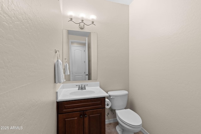 half bathroom featuring vanity and toilet