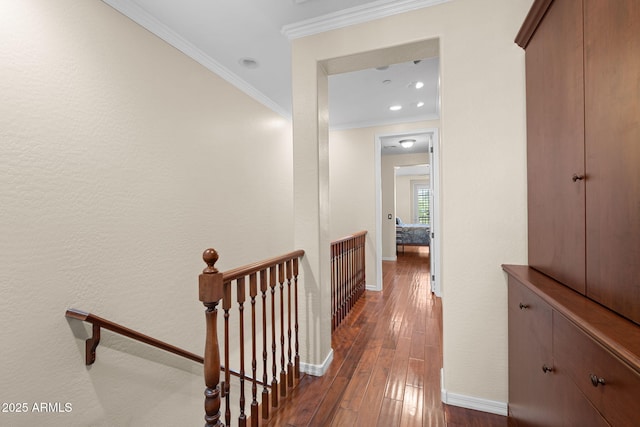 hall featuring ornamental molding, recessed lighting, baseboards, an upstairs landing, and dark wood-style floors