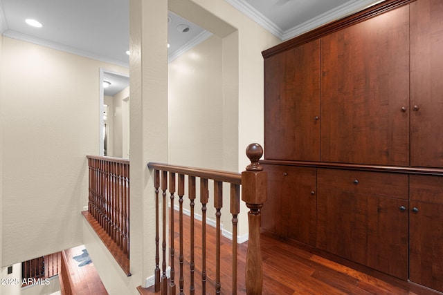 hall with crown molding, recessed lighting, an upstairs landing, and wood finished floors