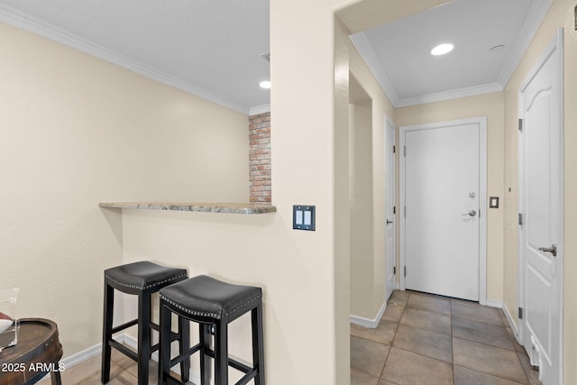 hall with baseboards, ornamental molding, and recessed lighting