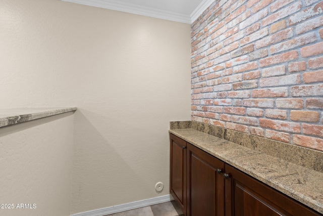 bathroom featuring crown molding and baseboards