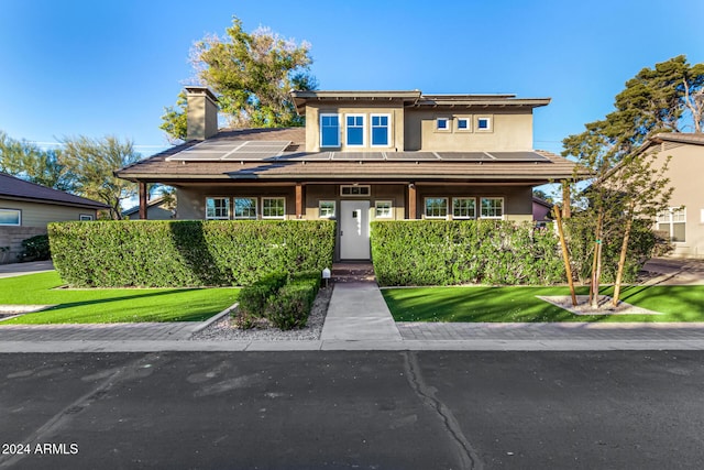 prairie-style home featuring a front lawn