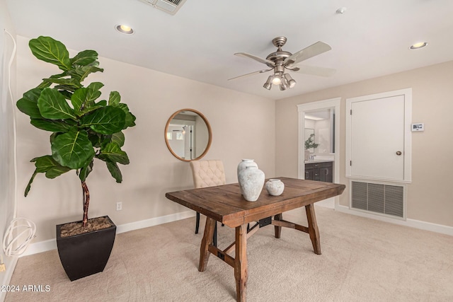 carpeted office space with ceiling fan