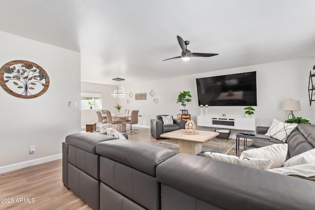 living room with ceiling fan and light wood-type flooring