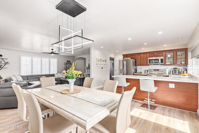 dining area featuring ceiling fan and light wood-type flooring