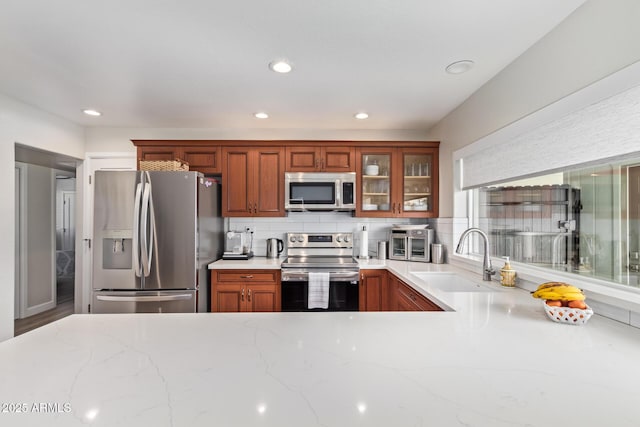 kitchen featuring tasteful backsplash, sink, and stainless steel appliances