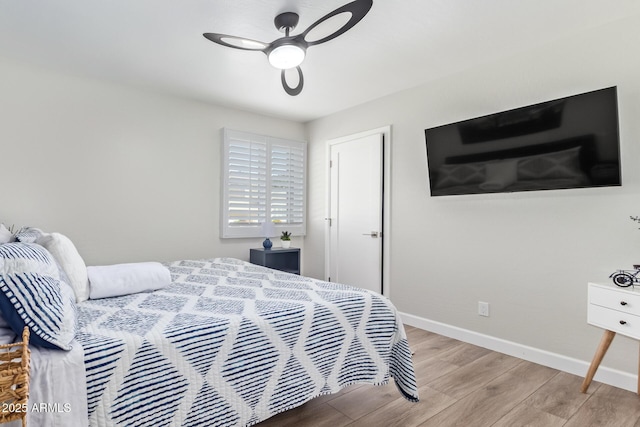 bedroom with light hardwood / wood-style floors and ceiling fan