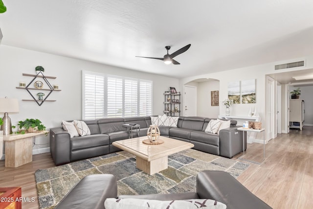 living room featuring hardwood / wood-style floors and ceiling fan