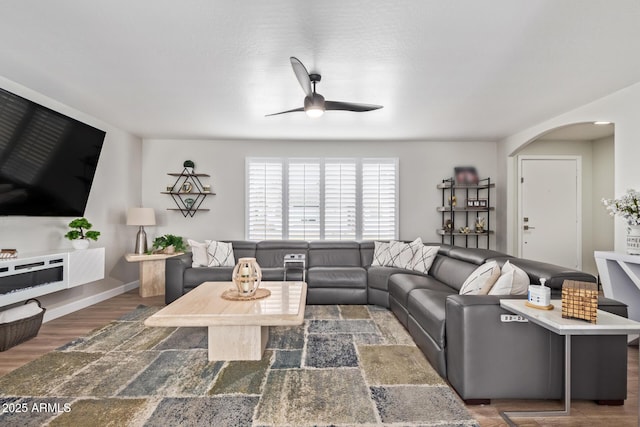 living room featuring dark hardwood / wood-style floors and ceiling fan