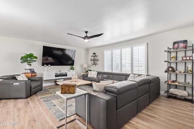 living room featuring ceiling fan and light hardwood / wood-style flooring